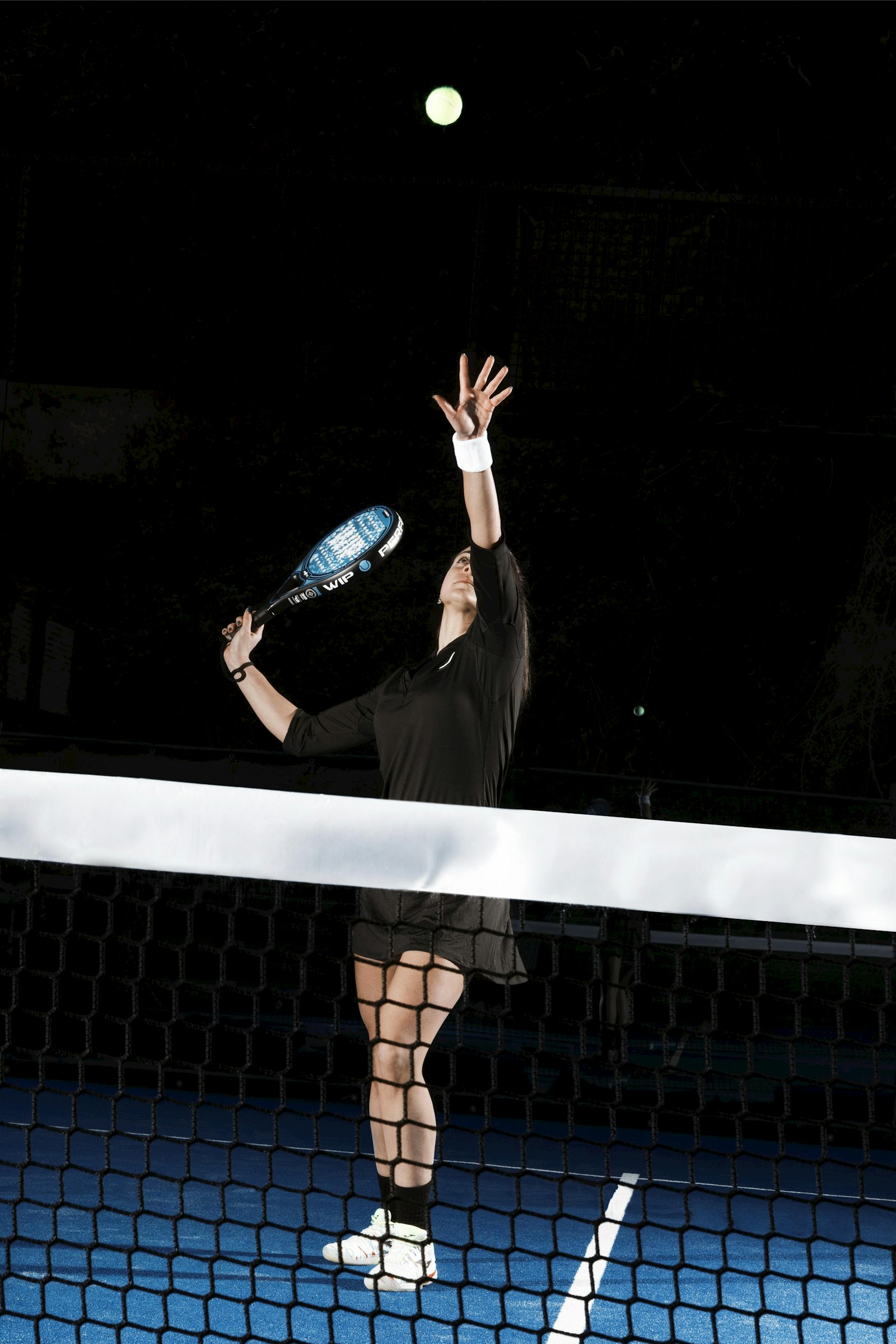 A player striking the ball at the net